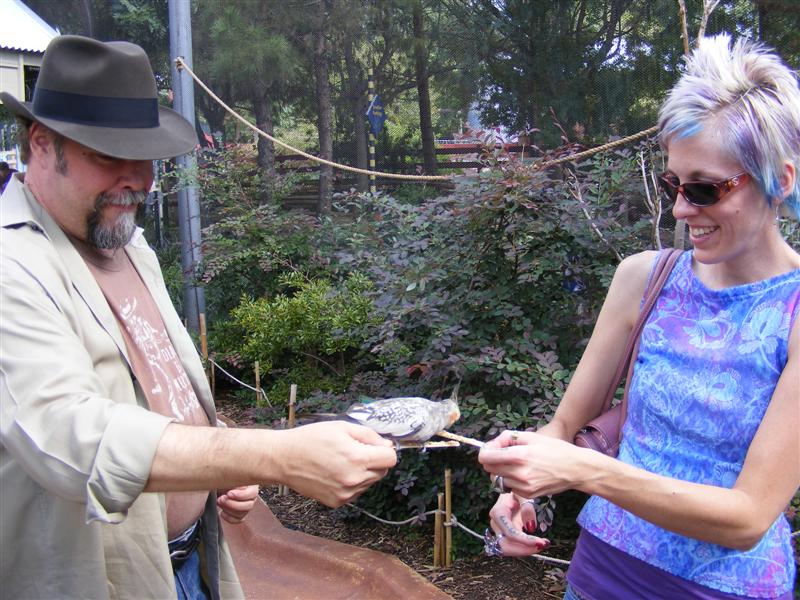 Jess2ndBDay_DALZoo (70) (Medium).JPG - Uncle Charles and Kelly feed a bird?  Interestingly enough, Kelly and the bird have matching hairdo's!